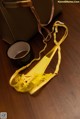 A pair of yellow lingerie sitting on top of a wooden table.