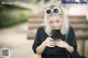 A woman sitting on a bench looking at her phone.