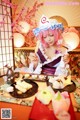 A woman sitting at a table with a plate of food.