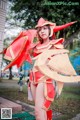 A woman in a red and gold costume posing for a picture.