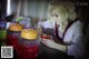 A woman sitting at a table with a bowl of food.