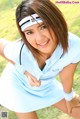 A woman in a blue and white uniform posing for a picture.