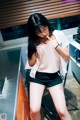 A woman standing in a kitchen next to a counter.