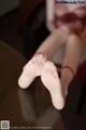 A close up of a person's feet on a table.