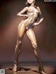 A woman in a shiny gold bodysuit posing for a picture.