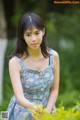 A woman in a blue dress posing for a picture.