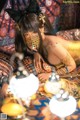 A woman in a gold outfit laying on a bed.